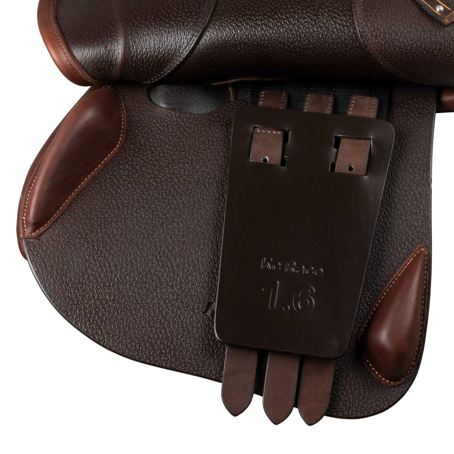 Close-up of a brown leather saddle with a brand label on a white background