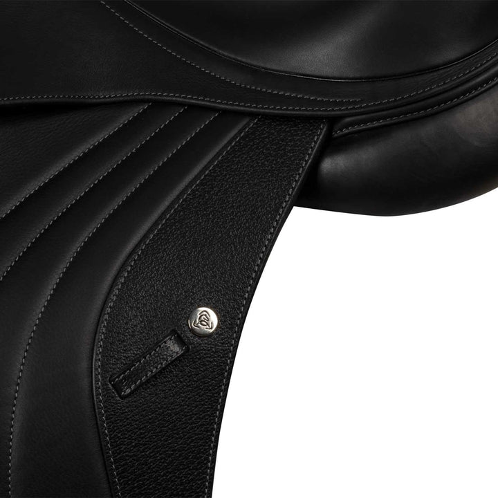 Close-up of a black leather saddle with a brand logo on a white background